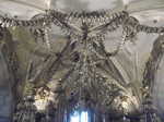 A chandelier and ceiling decorations made from human bones at the Sedlee Ossuary