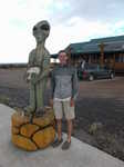 Myself with a statue of an alien holding a pie outside the Top of the World store