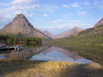 Two Medicine Lake perfectly reflecting the mountains behind it