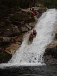 Sliding down a large waterfall, although not the biggest one on the trip