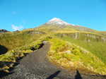 The peak of Mt. Taranaki very high above and with new snow