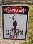 Danger propellers chop heads off. A graphic warning sign at the airstrip