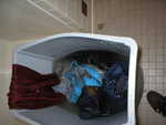 Cleaning clothes in a garbage can