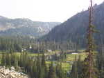 View of a small lake in a partial clearing in the mountains