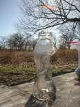 Glass bottle distorted by the campfire