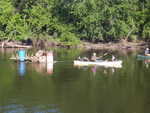 A Project AWARE volunteer uses ingenuity to tow a large amount of trash behind his canoe