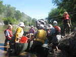 Loading a giant tractor tire into a canoe-maran