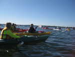 Kayakers cheering for the last swimmers